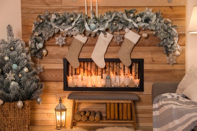 Festive room interior with decorative fireplace and Christmas stockings