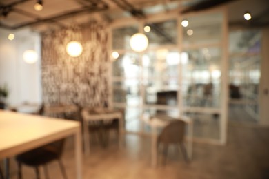 Photo of Blurred view of beautiful modern cafe interior