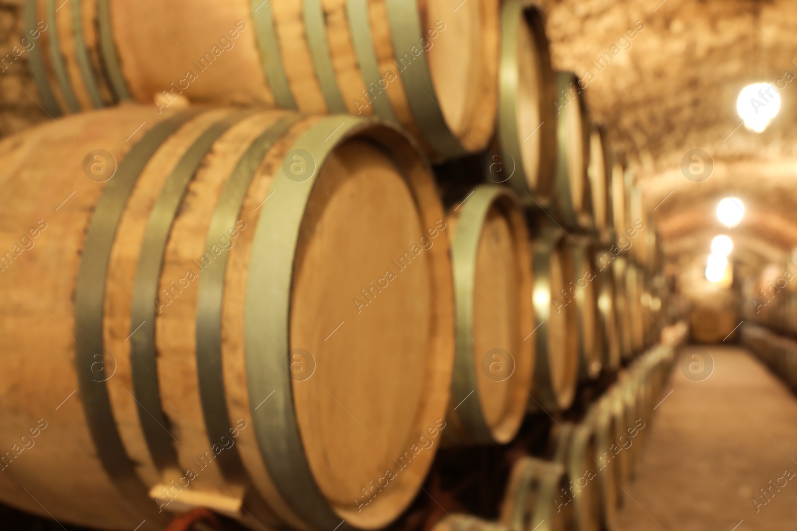 Photo of Large wooden barrels in wine cellar, closeup