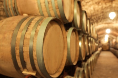 Photo of Large wooden barrels in wine cellar, closeup