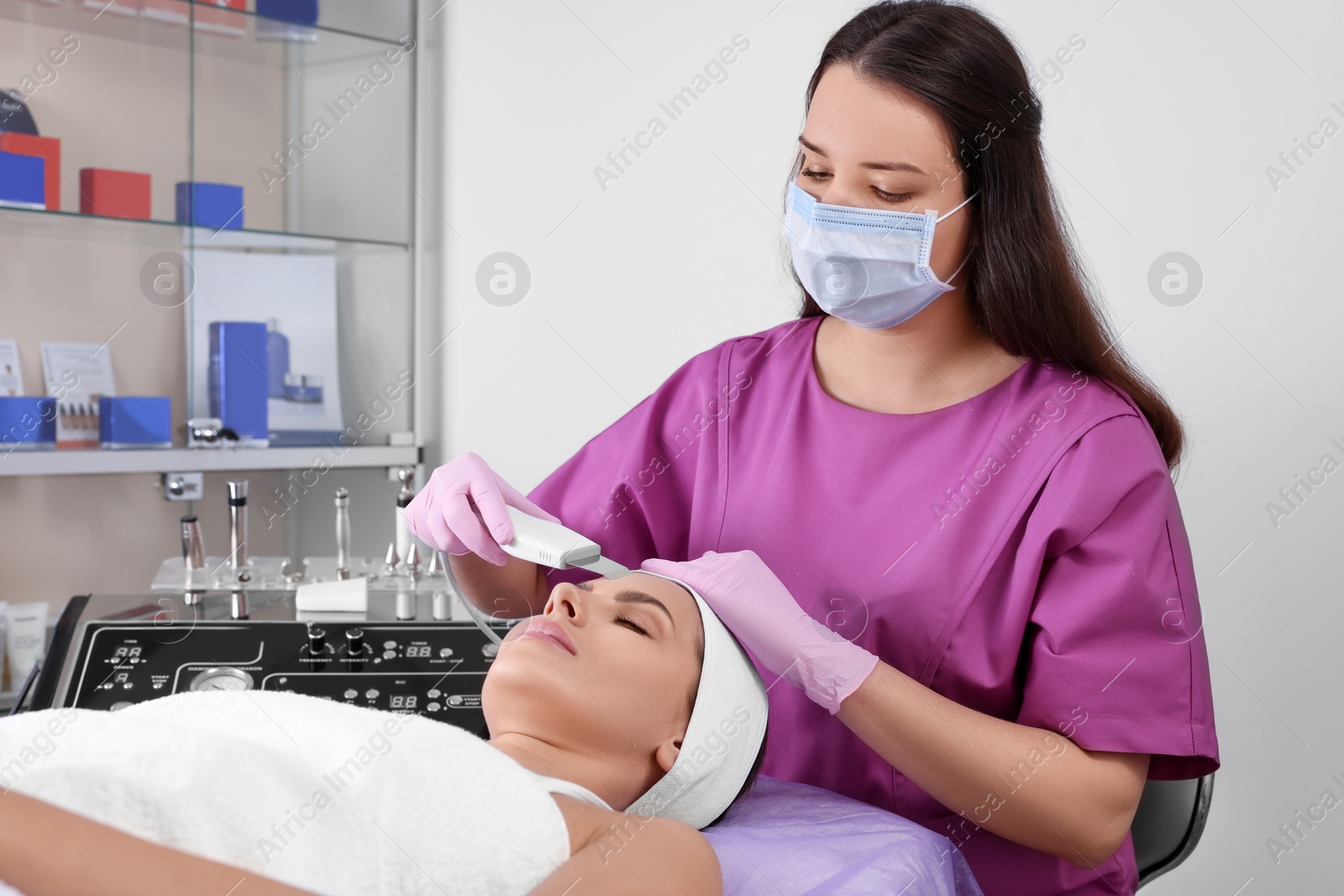 Photo of Young woman undergoing cosmetic procedure in beauty salon. Microcurrent therapy