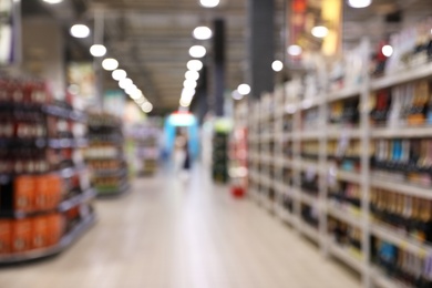 Photo of Blurred view of modern supermarket interior. Bokeh effect