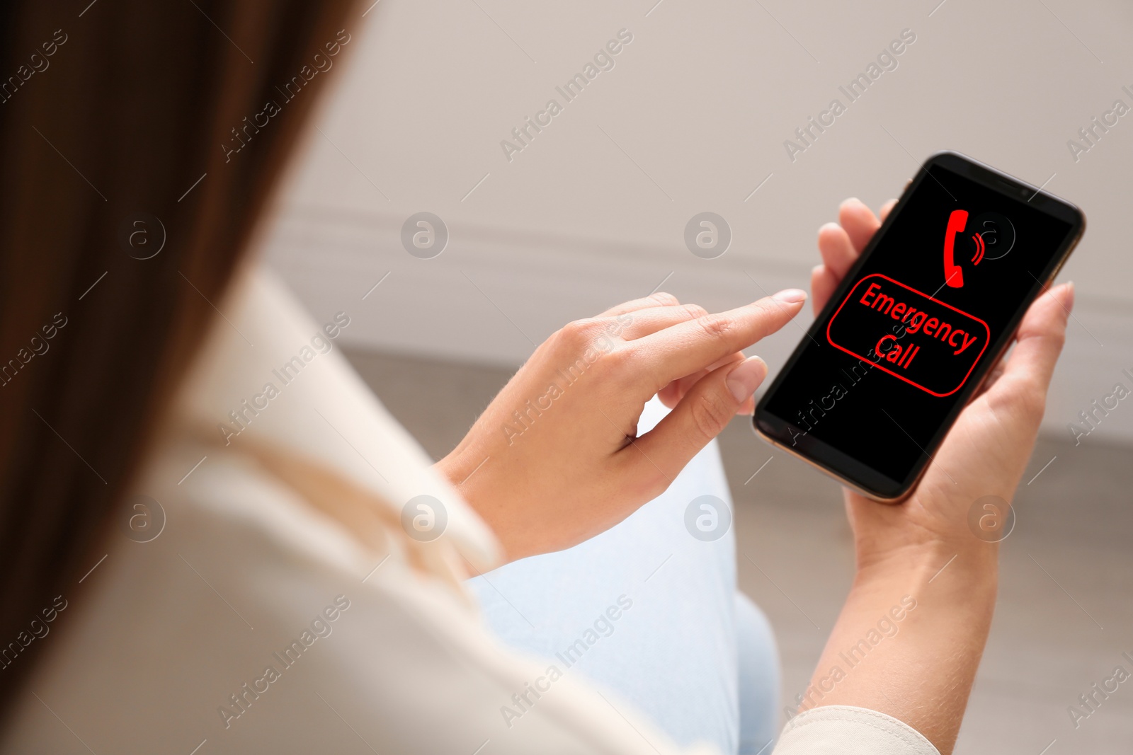 Image of Hotline service. Woman making emergency call via smartphone indoors, closeup