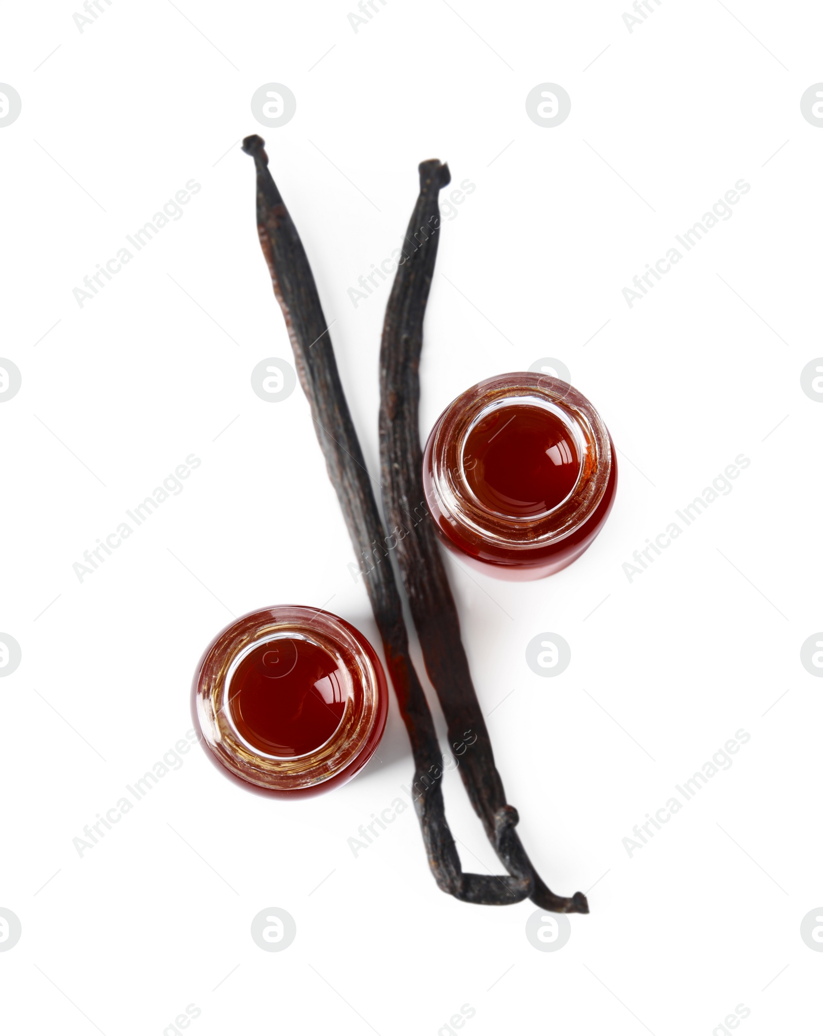 Photo of Vanilla extract and dry pods isolated on white, top view