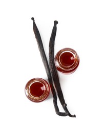 Photo of Vanilla extract and dry pods isolated on white, top view