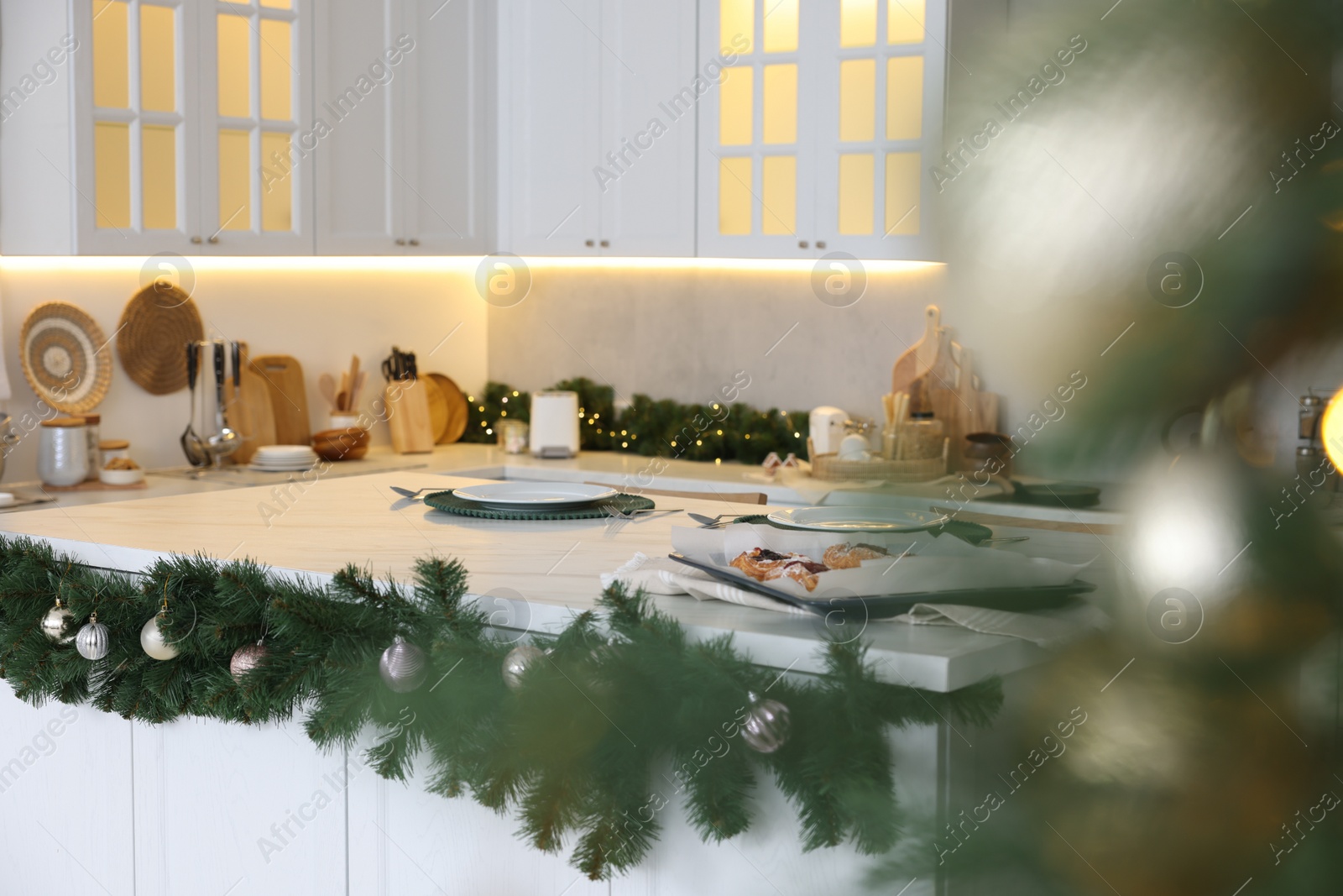 Photo of Cozy spacious kitchen decorated for Christmas. Interior design