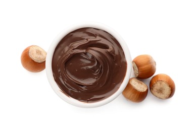 Photo of Bowl of chocolate paste with hazelnuts on white background, top view