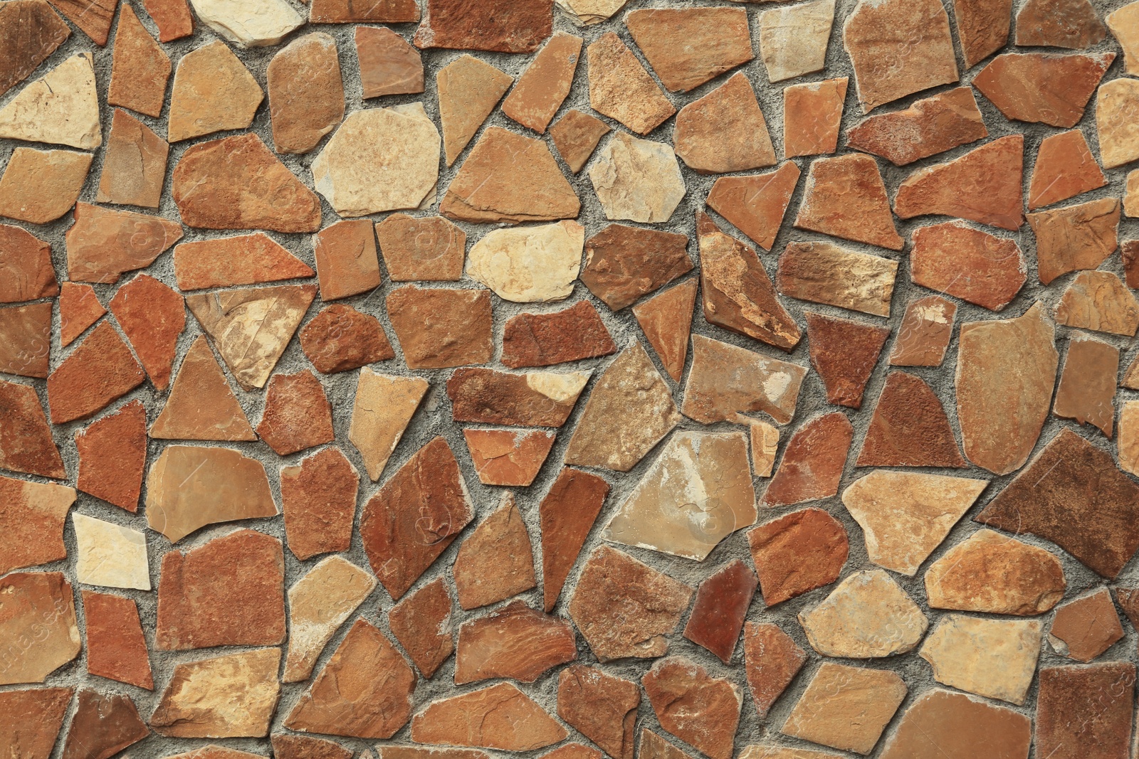 Photo of Texture of brown stone wall as background