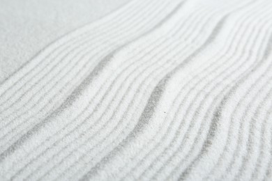 Photo of Zen rock garden. Wave pattern on white sand, closeup