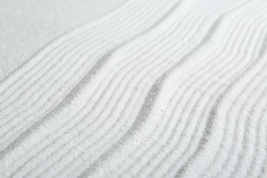 Zen rock garden. Wave pattern on white sand, closeup