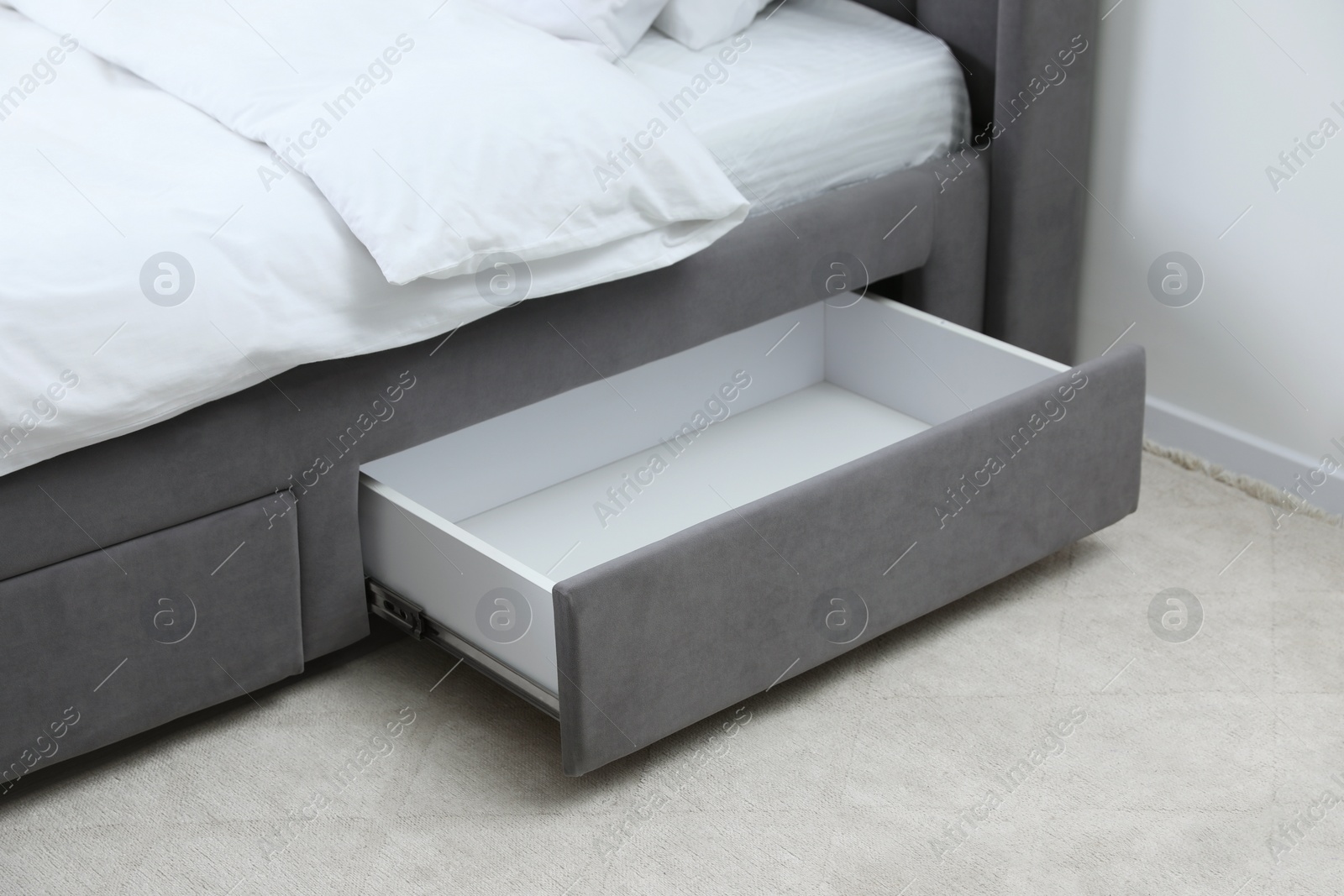 Photo of Storage drawer for bedding under modern bed in room