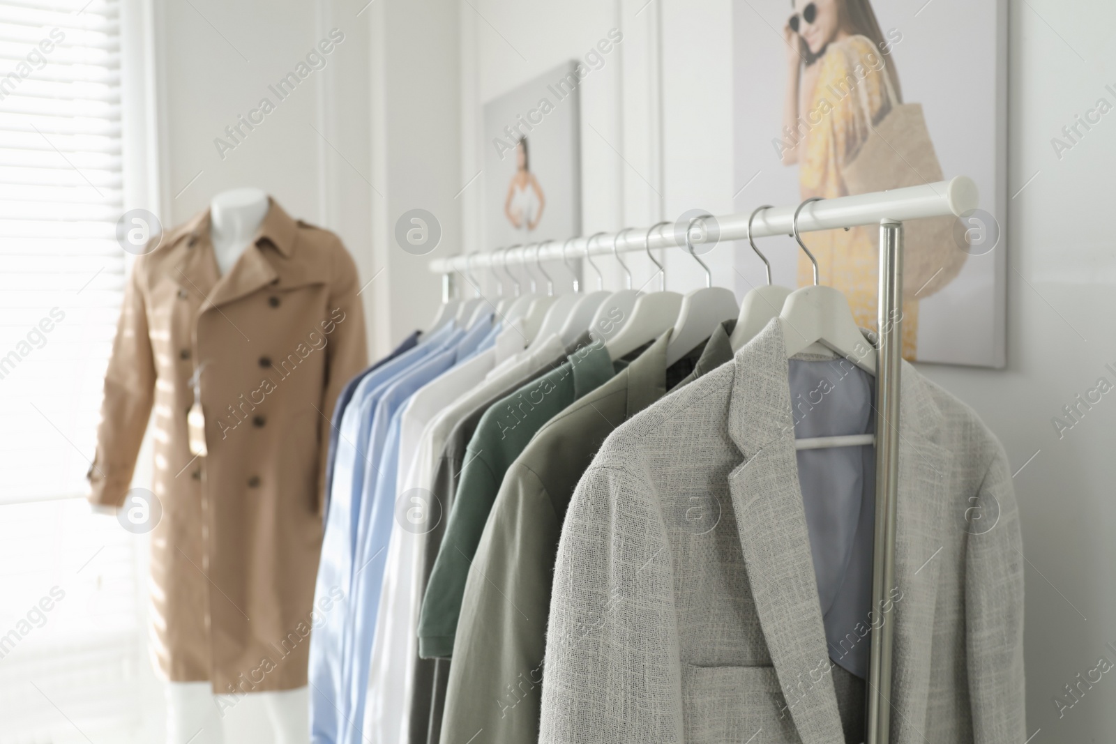 Photo of Collection of stylish women's clothes in modern boutique