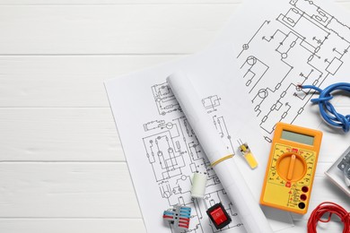 Photo of Flat lay composition with wiring diagrams and digital multimeter on white wooden table, space for text