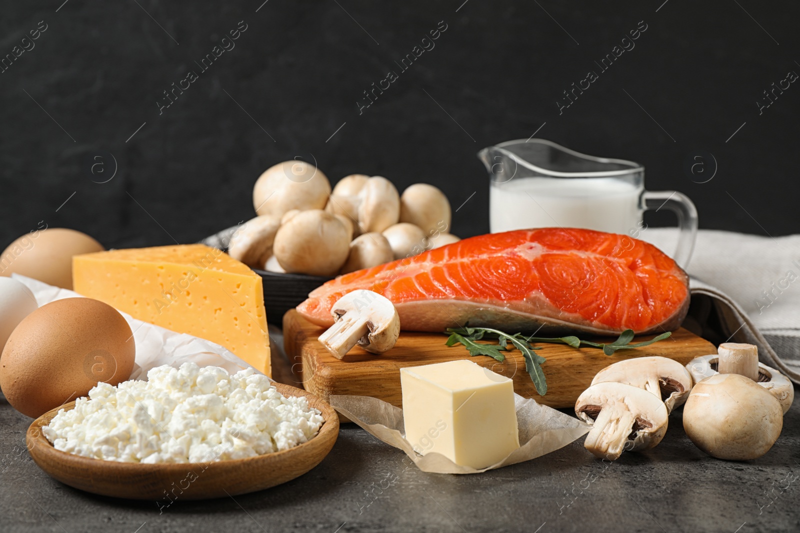 Photo of Fresh products rich in vitamin D on grey table