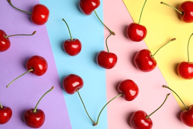 Photo of Flat lay composition with sweet cherries on color background