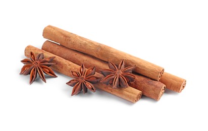 Photo of Aromatic cinnamon sticks and anise stars isolated on white