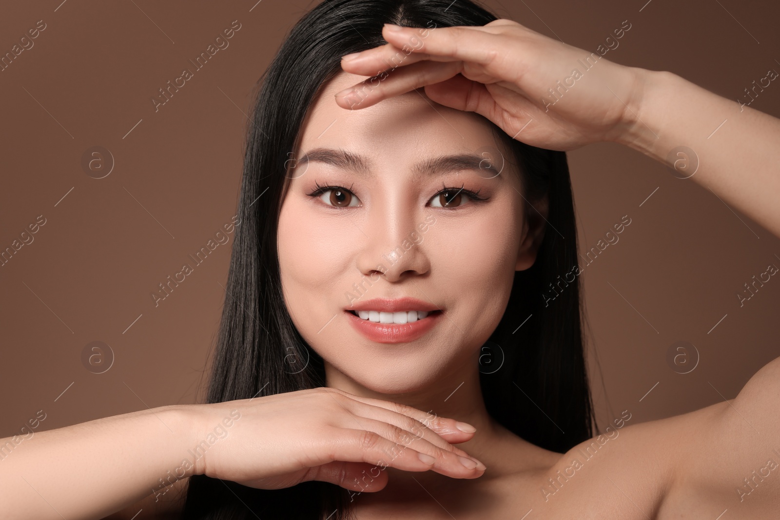 Photo of Portrait of beautiful woman on brown background