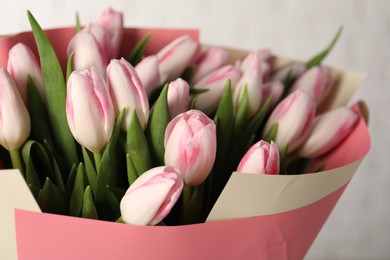 Photo of Beautiful bouquet of fresh pink tulips on light background, closeup