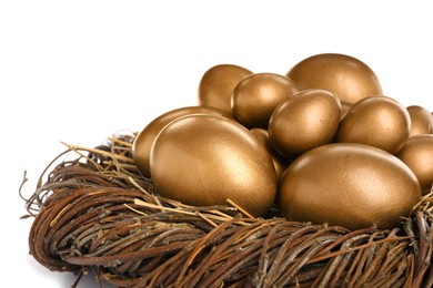 Photo of Many golden eggs in nest on white background