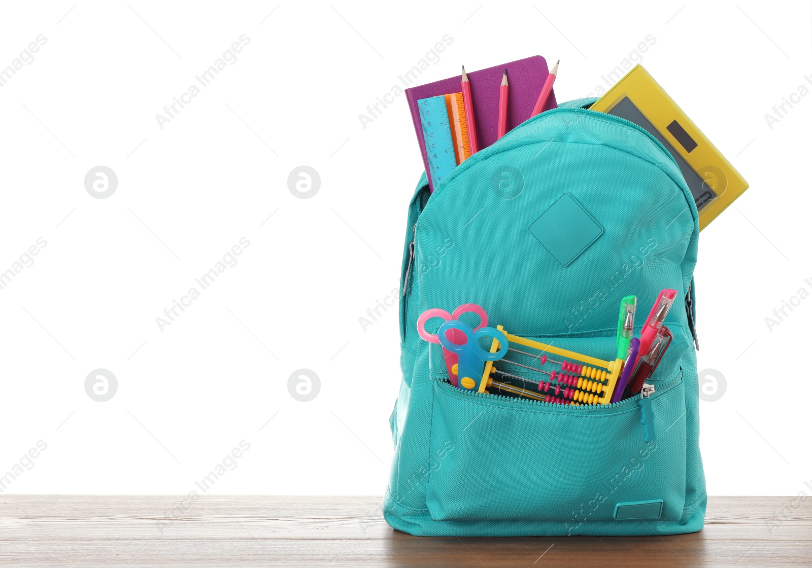 Photo of Bright backpack with school stationery on white background