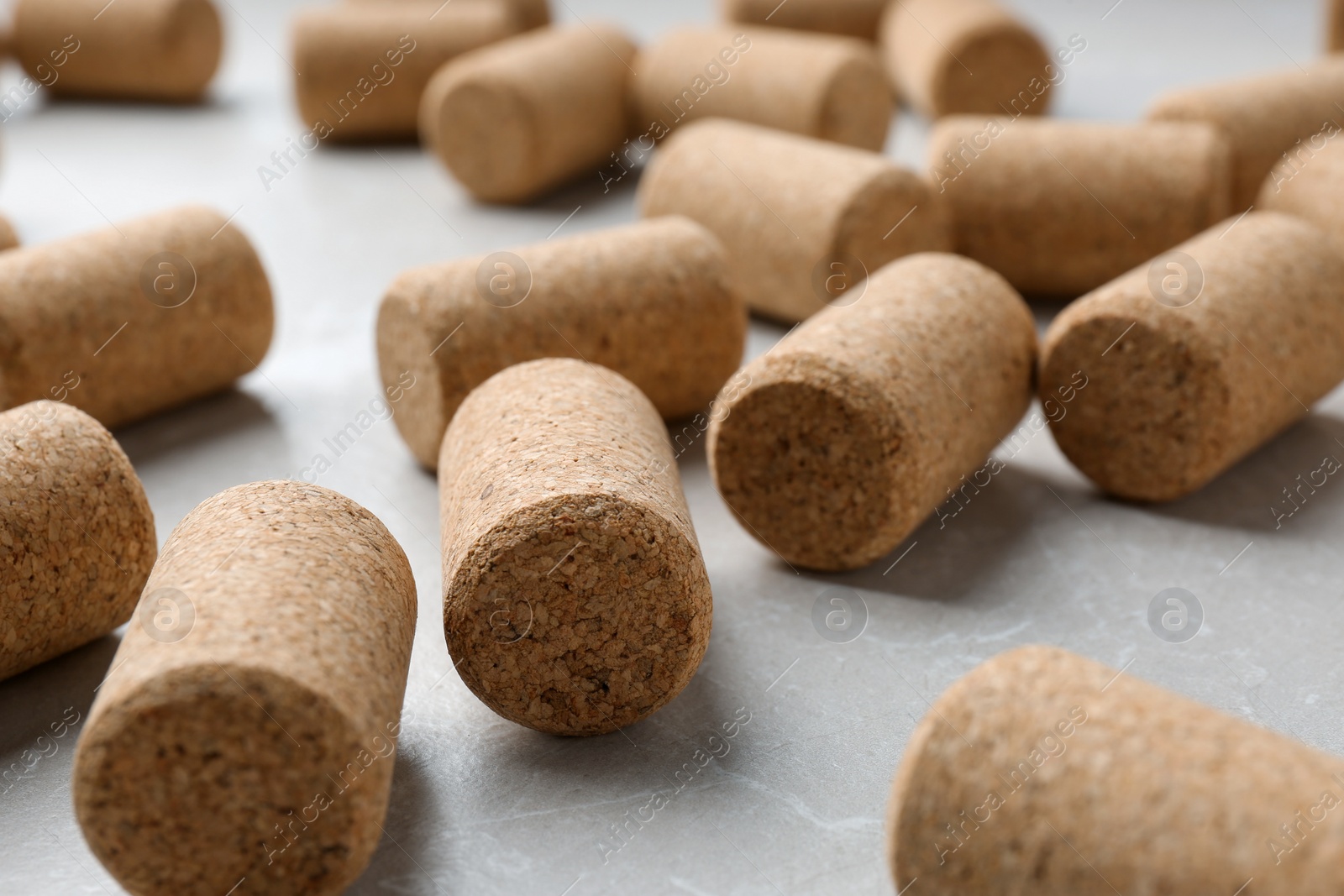 Photo of Wine bottle corks on light grey marble table, closeup