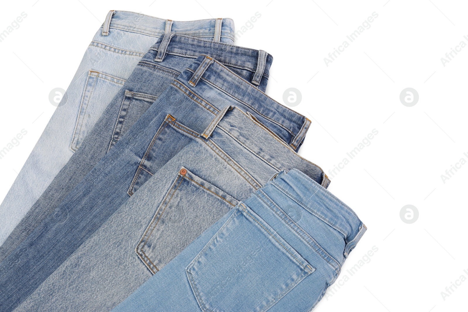 Photo of Different stylish jeans isolated on white, top view