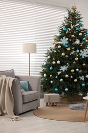 Christmas tree in room decorated for holiday. Festive interior design