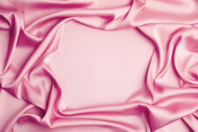 Image of Crumpled pink silk fabric as background, top view. Space for text