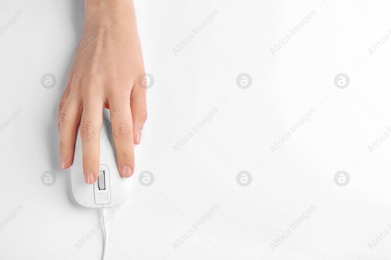 Photo of Woman using modern wired optical mouse on white background, top view