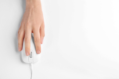 Photo of Woman using modern wired optical mouse on white background, top view