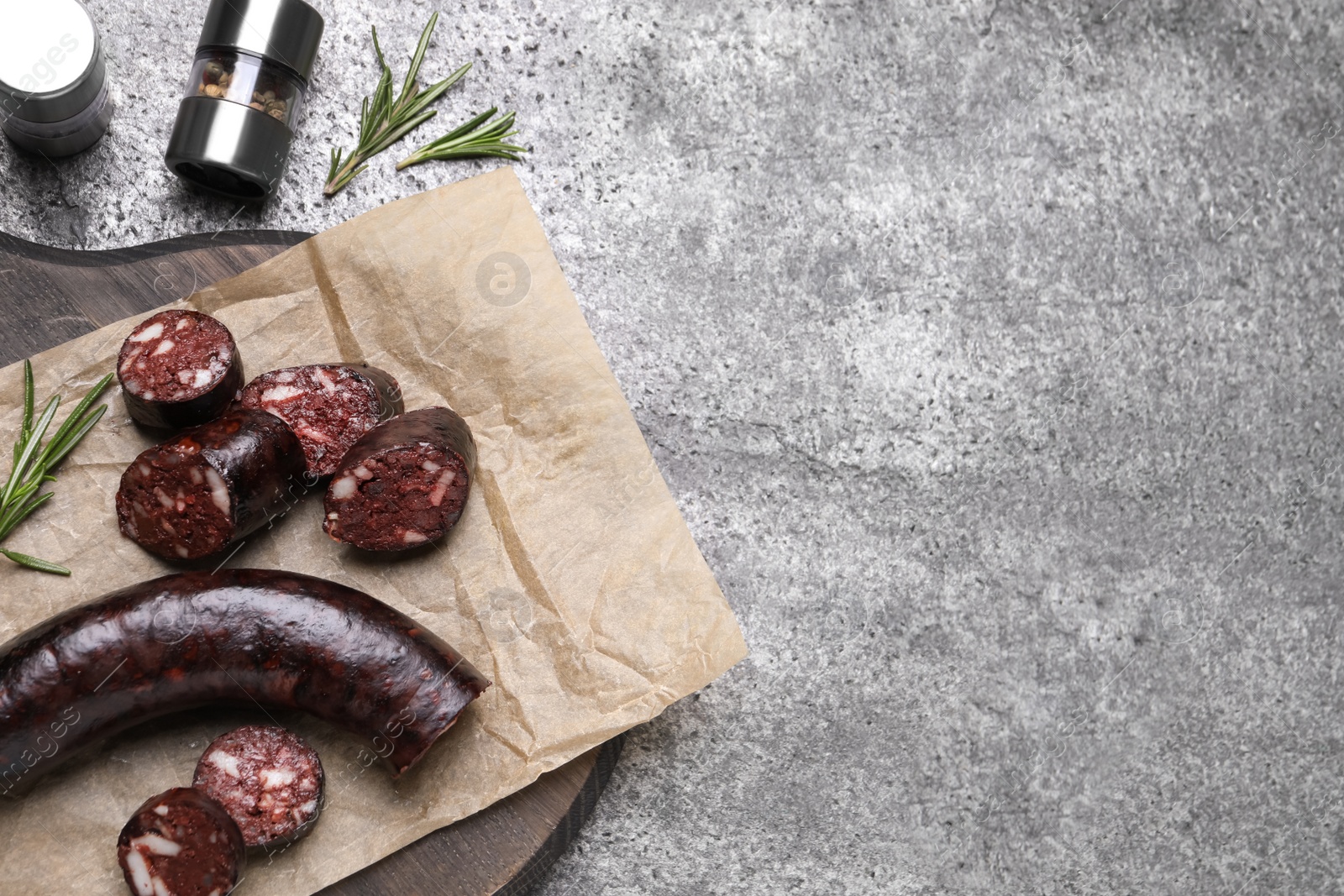 Photo of Tasty blood sausages with rosemary, flat lay. Space for text