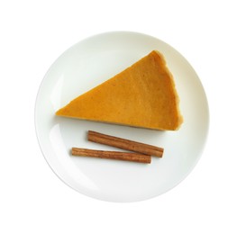 Photo of Piece of delicious pumpkin pie with cinnamon sticks isolated on white, top view