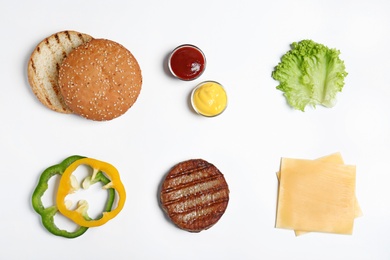 Composition with burger ingredients on white background, top view