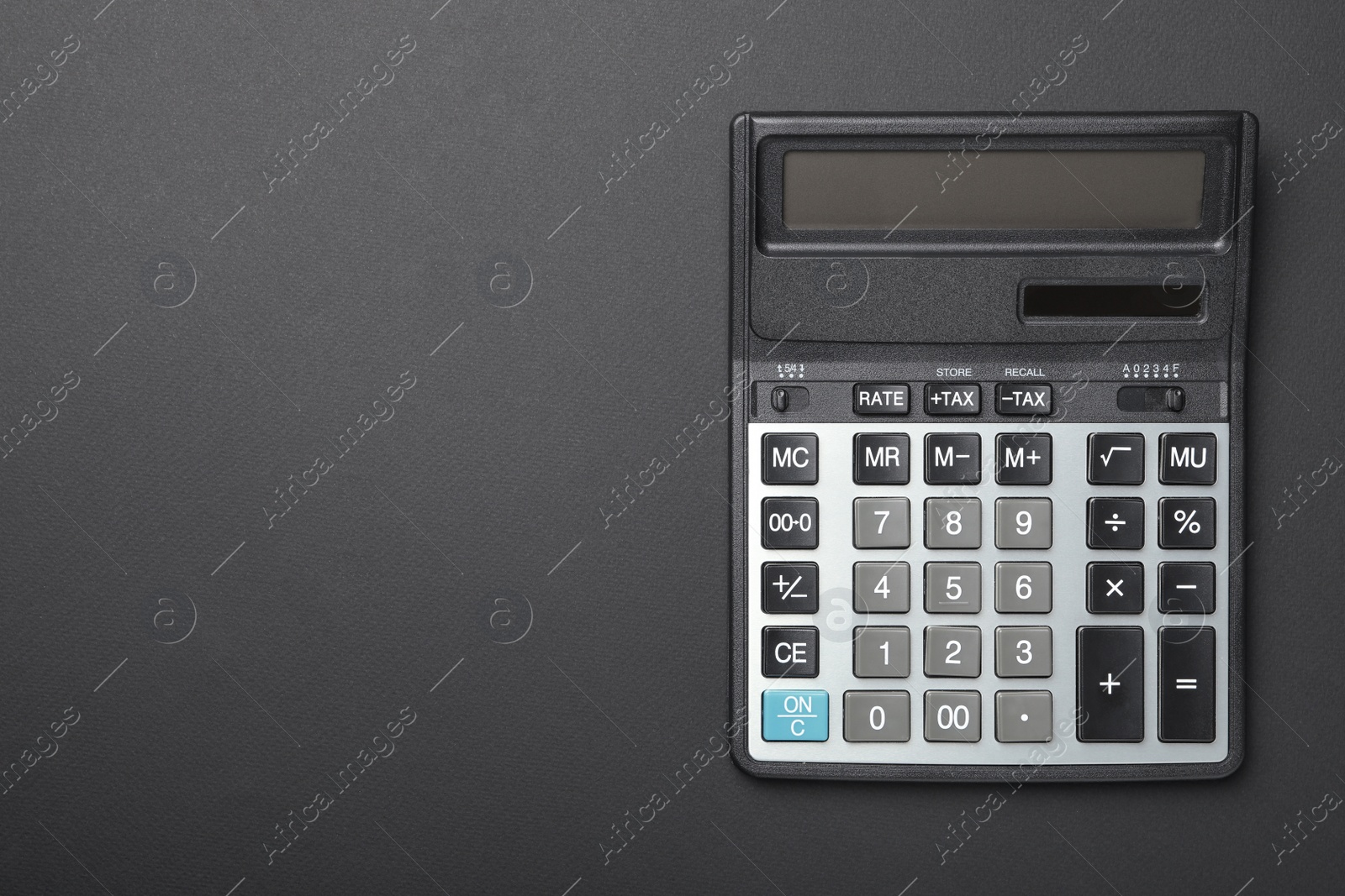 Photo of Calculator and space for text on black background, top view. Tax accounting concept