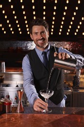 Photo of Bartender preparing fresh alcoholic cocktail in bar