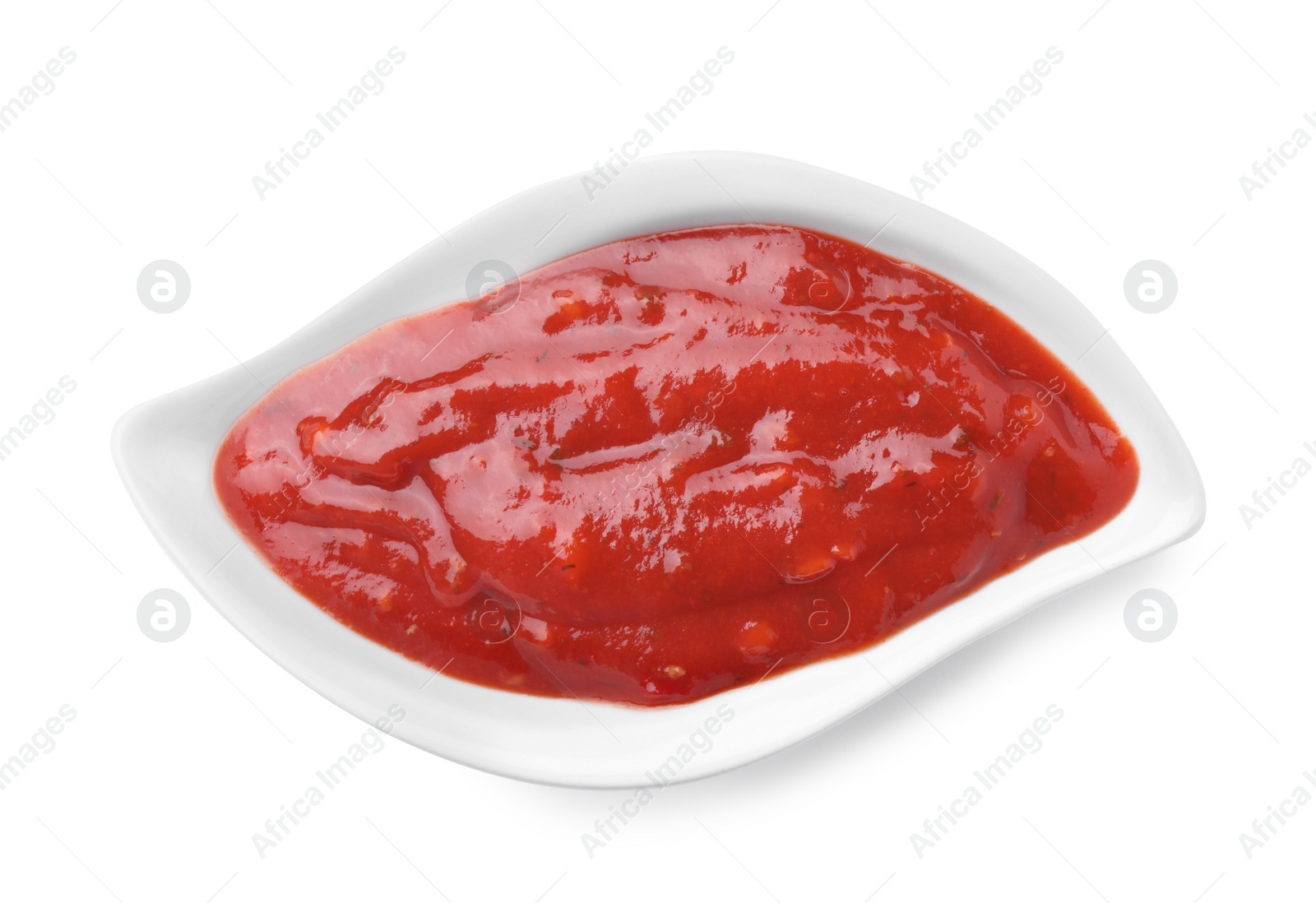 Photo of Gravy boat with red sauce isolated on white, top view