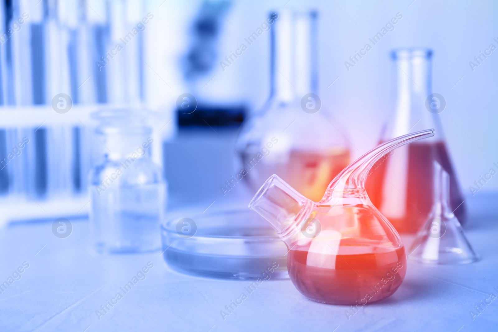 Image of Chemical glassware with samples on table indoors. Laboratory analysis