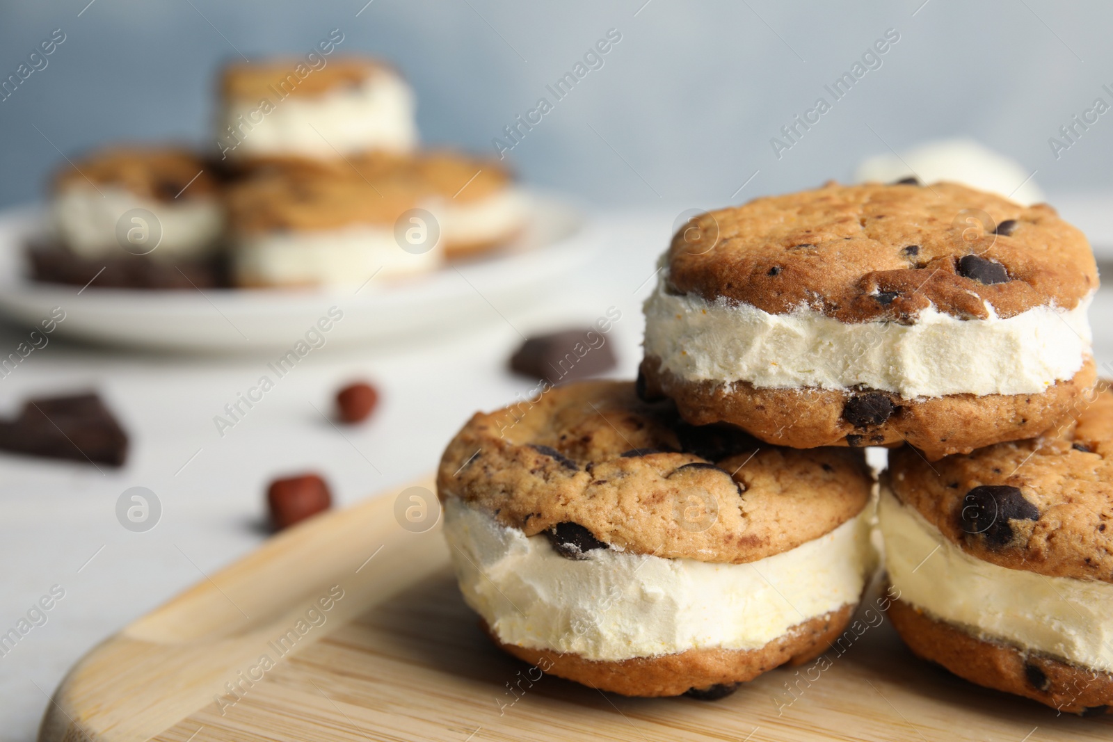 Photo of Sweet delicious ice cream cookie sandwiches on table, closeup. Space for text