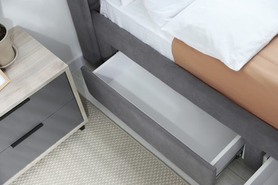 Photo of Storage drawer for bedding under modern bed in room