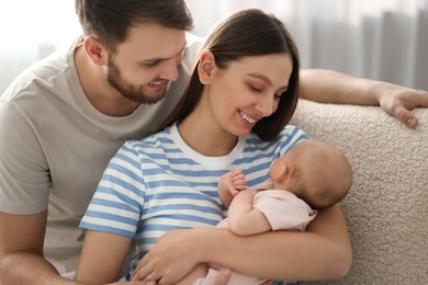 Photo of Happy family. Parents with their cute baby at home