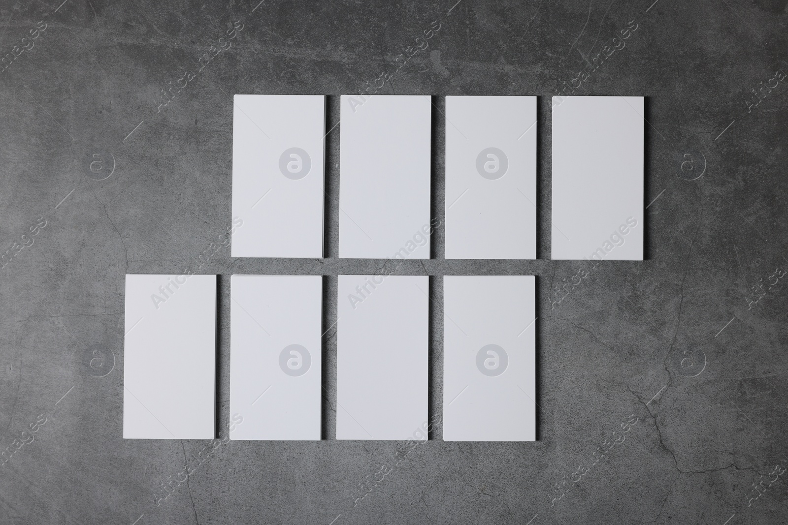 Photo of Blank business cards on grey textured background, top view. Mockup for design