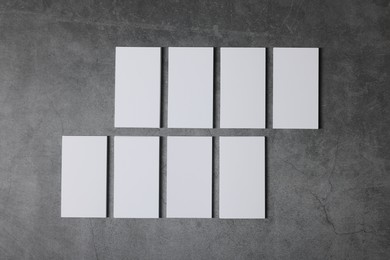 Photo of Blank business cards on grey textured background, top view. Mockup for design