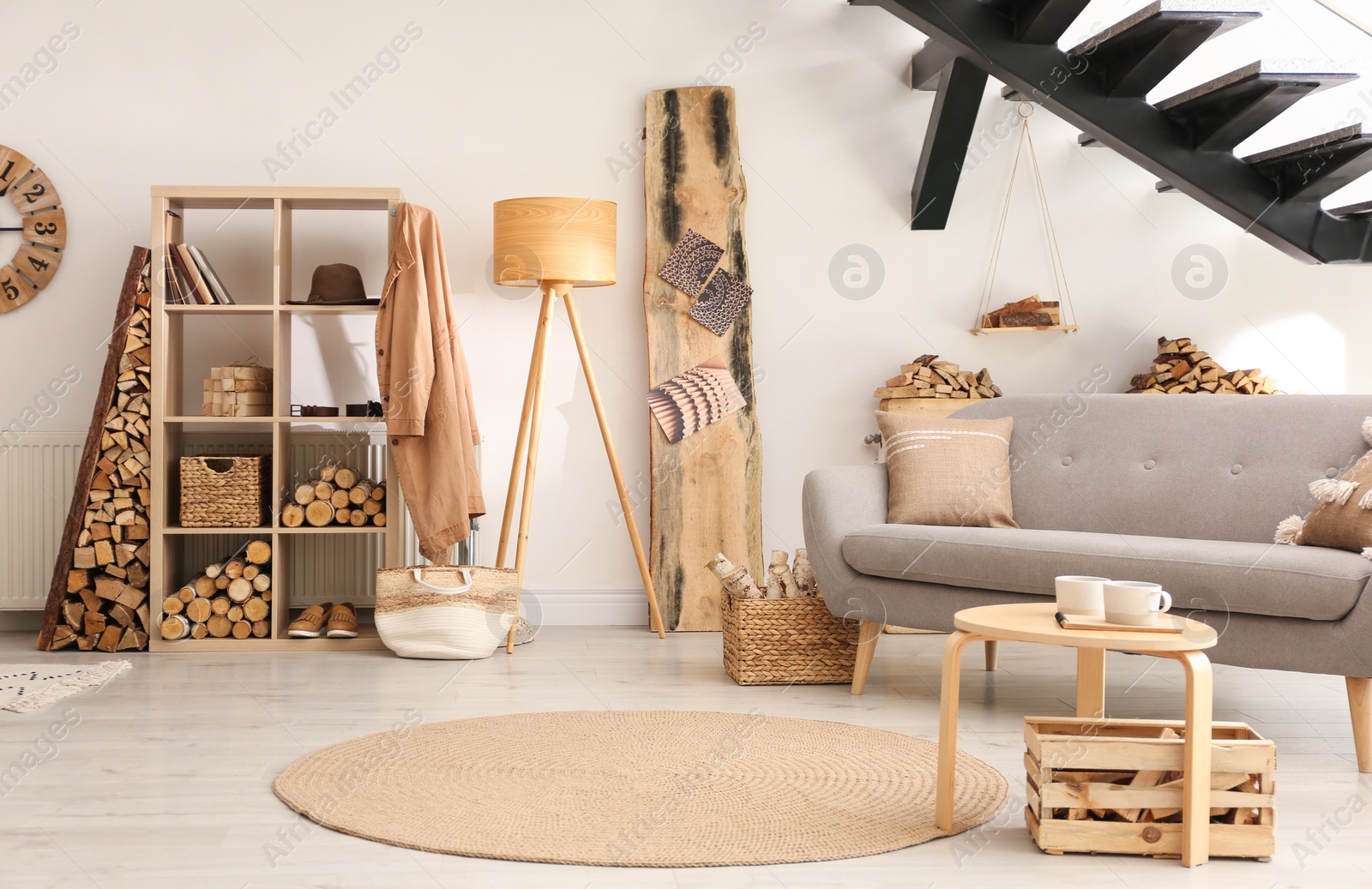 Photo of Stylish room interior with firewood as decorative element