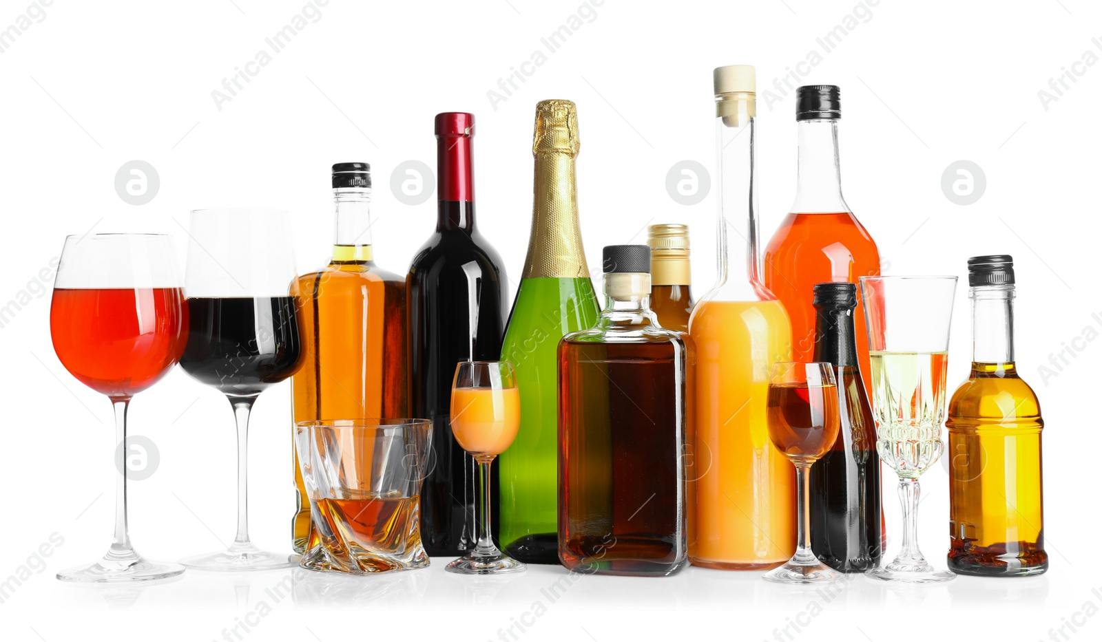 Photo of Bottles and glasses with different alcoholic drinks isolated on white