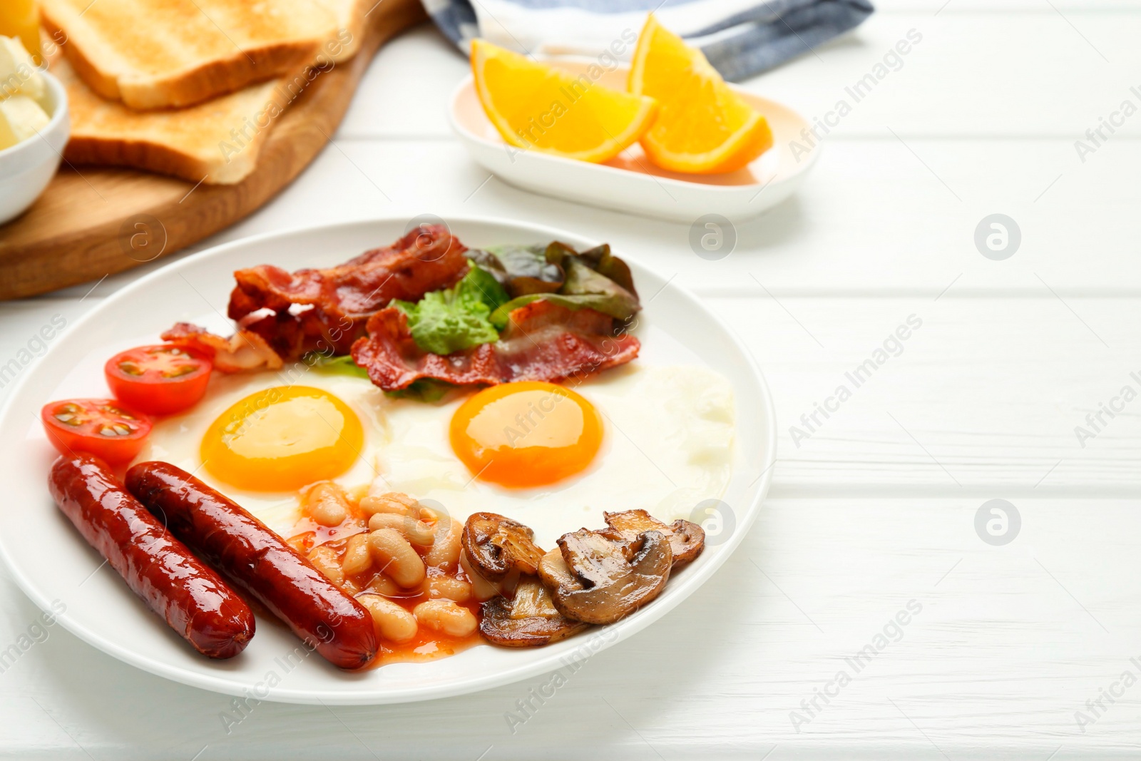 Photo of Delicious breakfast with sunny side up eggs on white wooden table