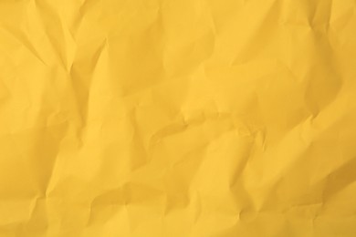 Photo of Sheet of crumpled orange paper as background, top view