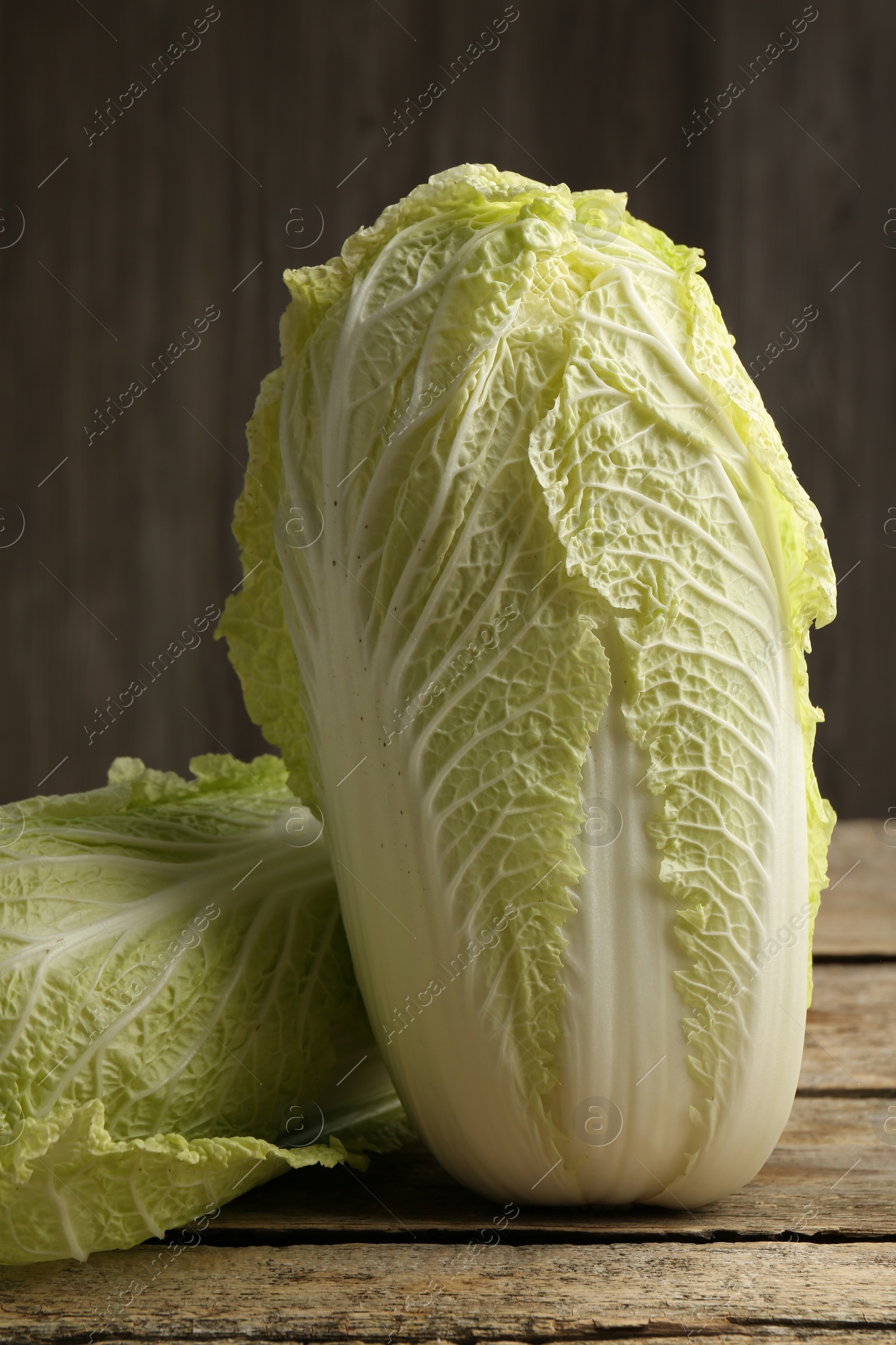 Photo of Fresh ripe Chinese cabbages on wooden table