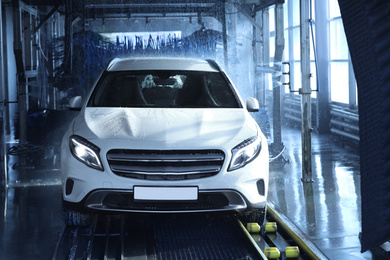 Photo of Modern auto undergoing cleaning at car wash