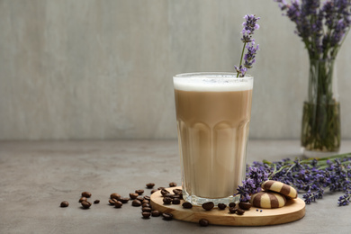 Delicious coffee with lavender and cookies on grey table. Space for text