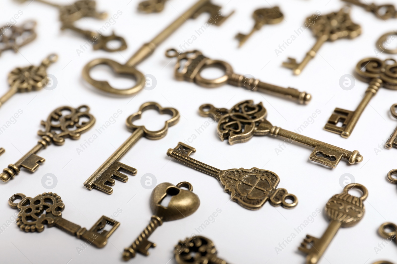 Photo of Bronze vintage ornate keys on white background